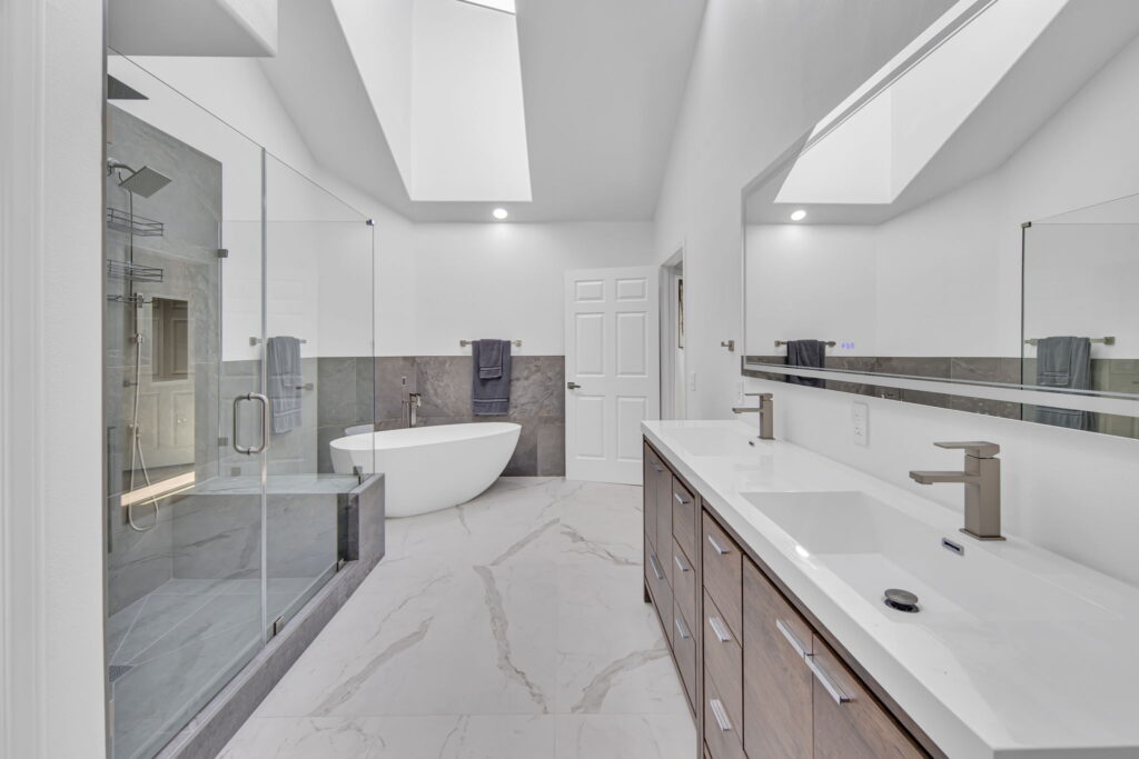 Master bath renovation with double vanity, skylight and freestanding tub in La Jolla