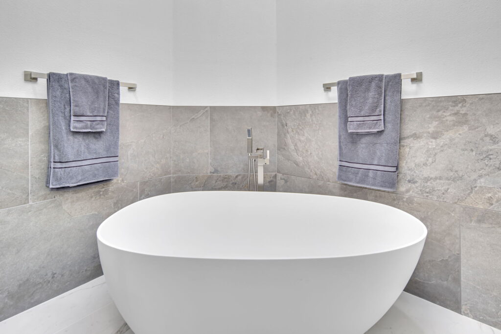 Freestanding tub with natural stone surround, bathroom remodeling in La Jolla by PBH Builders
