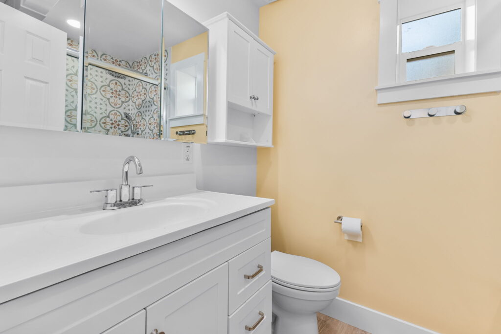 New ADU bathroom with white vanity and custom tile accents in Mission Hills San Diego