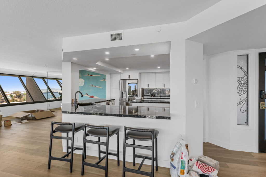 Full condo remodel with kitchen bar seating and custom mural wall in downtown San Diego