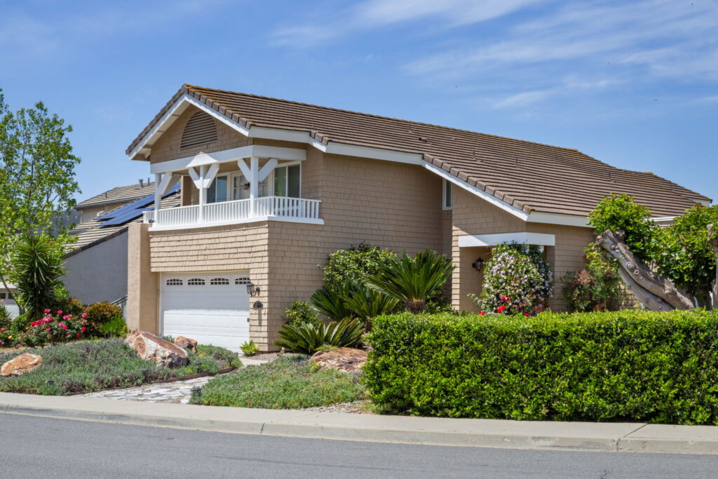 Home exterior remodel with new garage door and custom landscaping in San Diego