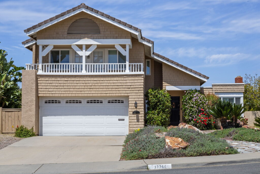 Exterior renovation with shake siding, white trim and drought-tolerant landscaping by PBH Builders