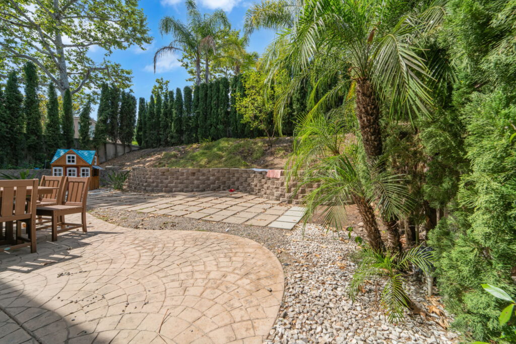 Paver patio and stamped concrete hardscape with outdoor dining area in San Diego