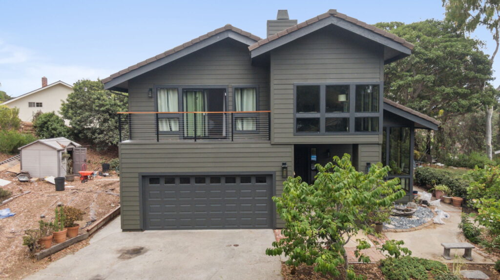Hillside home exterior remodel with new deck and cable railing in Carlsbad CA