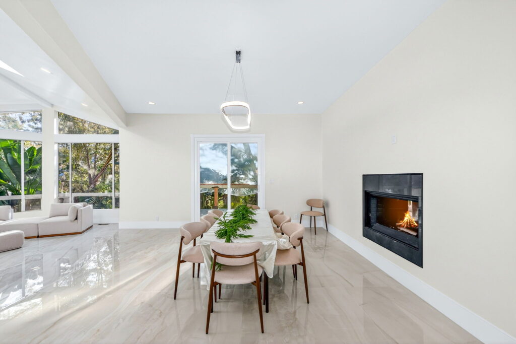Dining area with linear fireplace from a full home remodel by PBH Builders