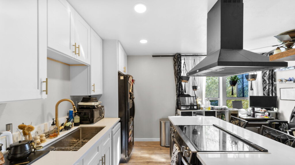 Modern black and white kitchen renovation with island cooktop in Chula Vista CA