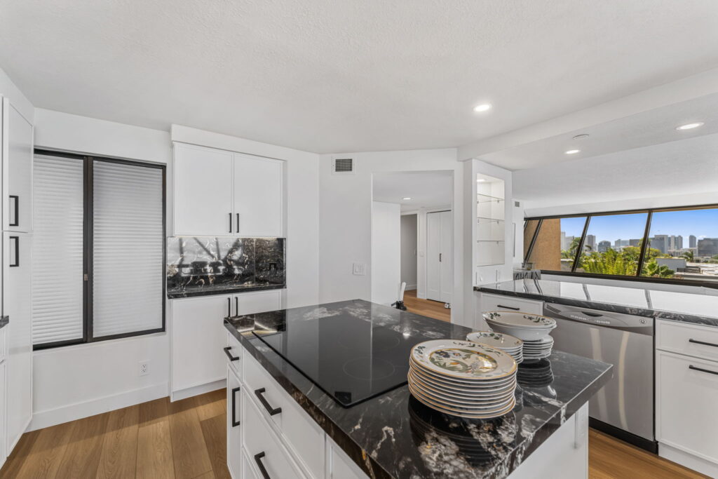 Contemporary kitchen renovation with exotic granite island by PBH Builders San Diego