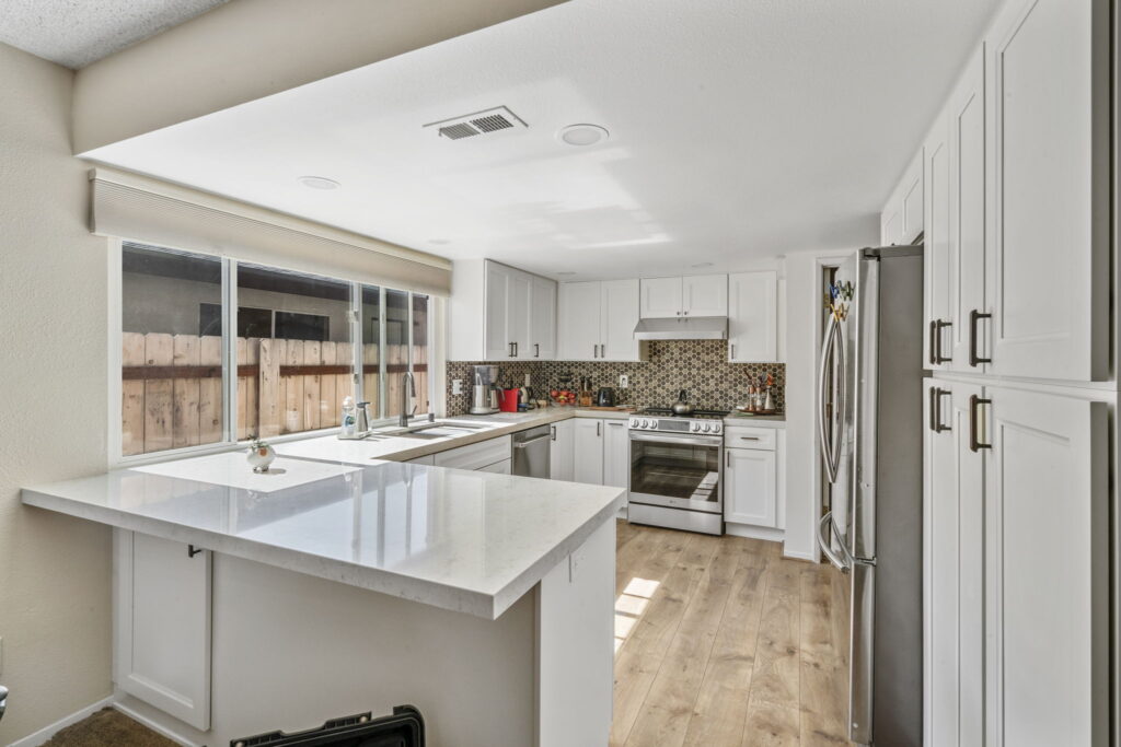White kitchen remodel with mosaic tile backsplash and center island in San Diego CA