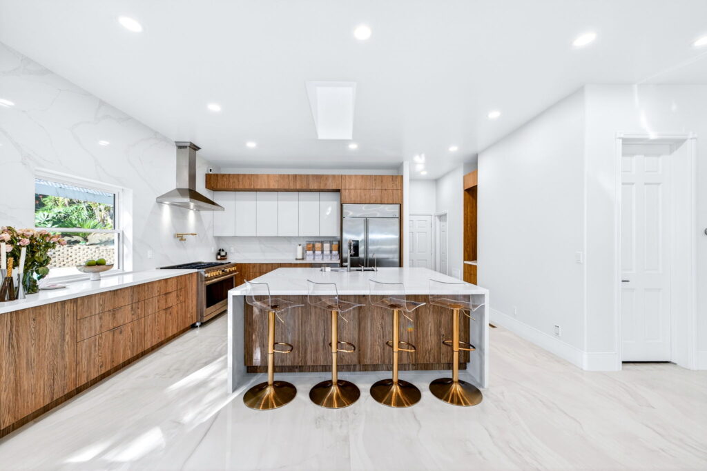 Luxury kitchen remodel in Escondido CA with waterfall quartz island and walnut cabinetry by PBH Builders