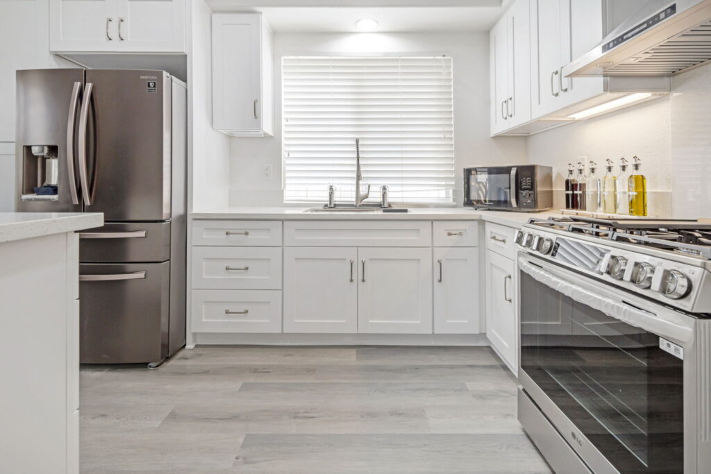 Remodeled kitchen with gas range and quartz counters in Chula Vista by PBH Builders