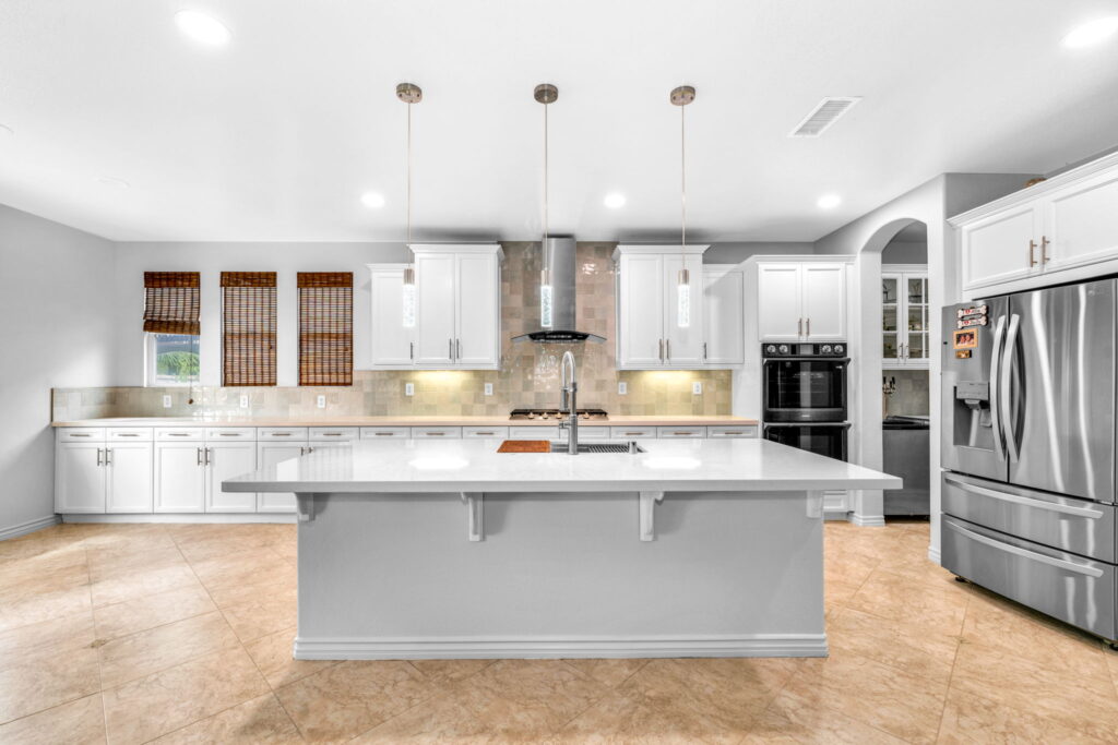 Spacious white shaker kitchen remodel with oversized island in Chula Vista CA by PBH Builders