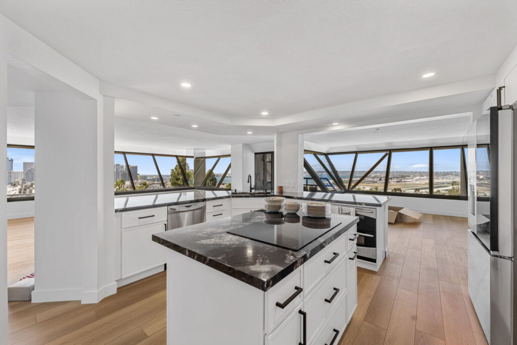 Downtown San Diego condo kitchen remodel with granite island and wide-plank oak flooring