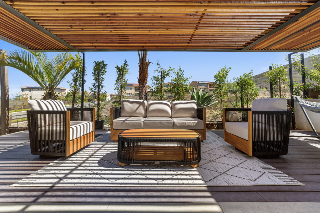 Shaded outdoor lounge under custom pergola by PBH Builders San Diego