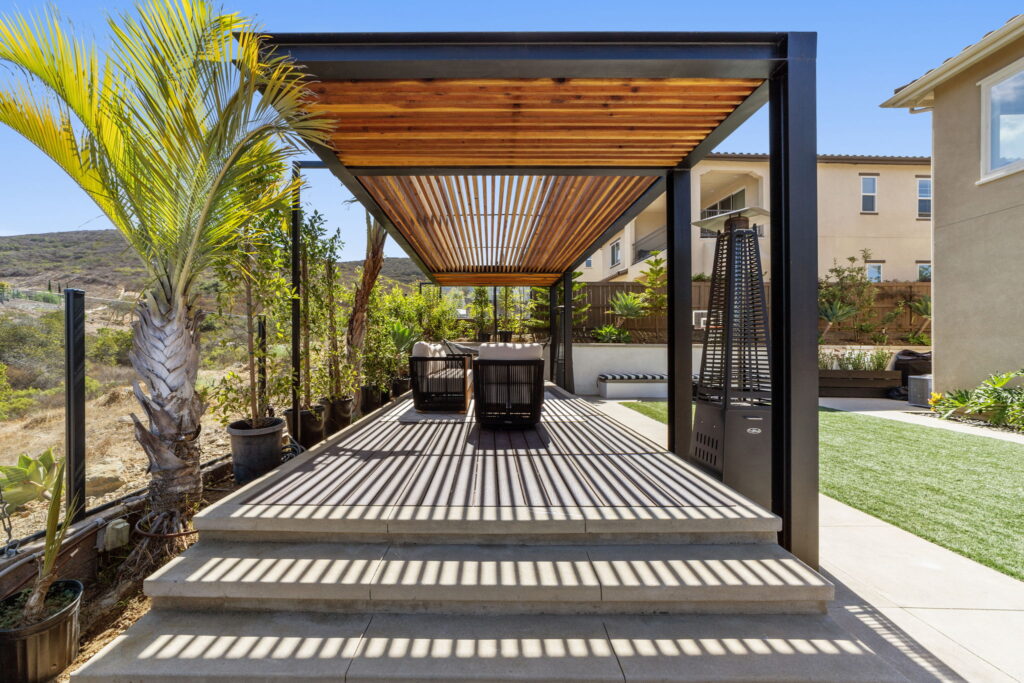 Custom wood-slat pergola with built-in deck seating, San Diego outdoor living project